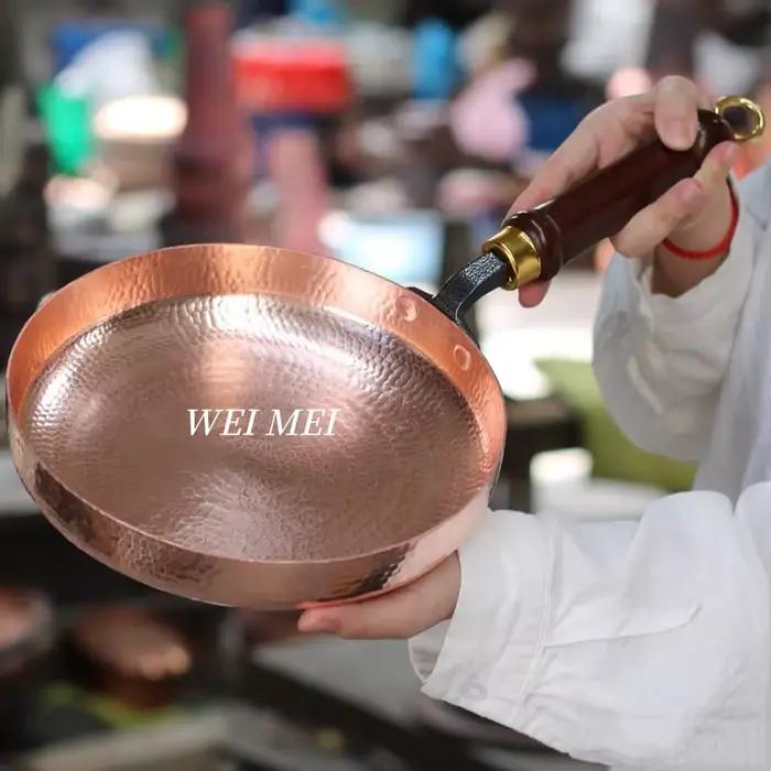 Poêle plate en cuivre artisanale rétro pour dîners de style occidental et pique-niques au feu de camp, avec manche en bois pour une prise en main confortable et une utilisation pratique à la maison ou en extérieur